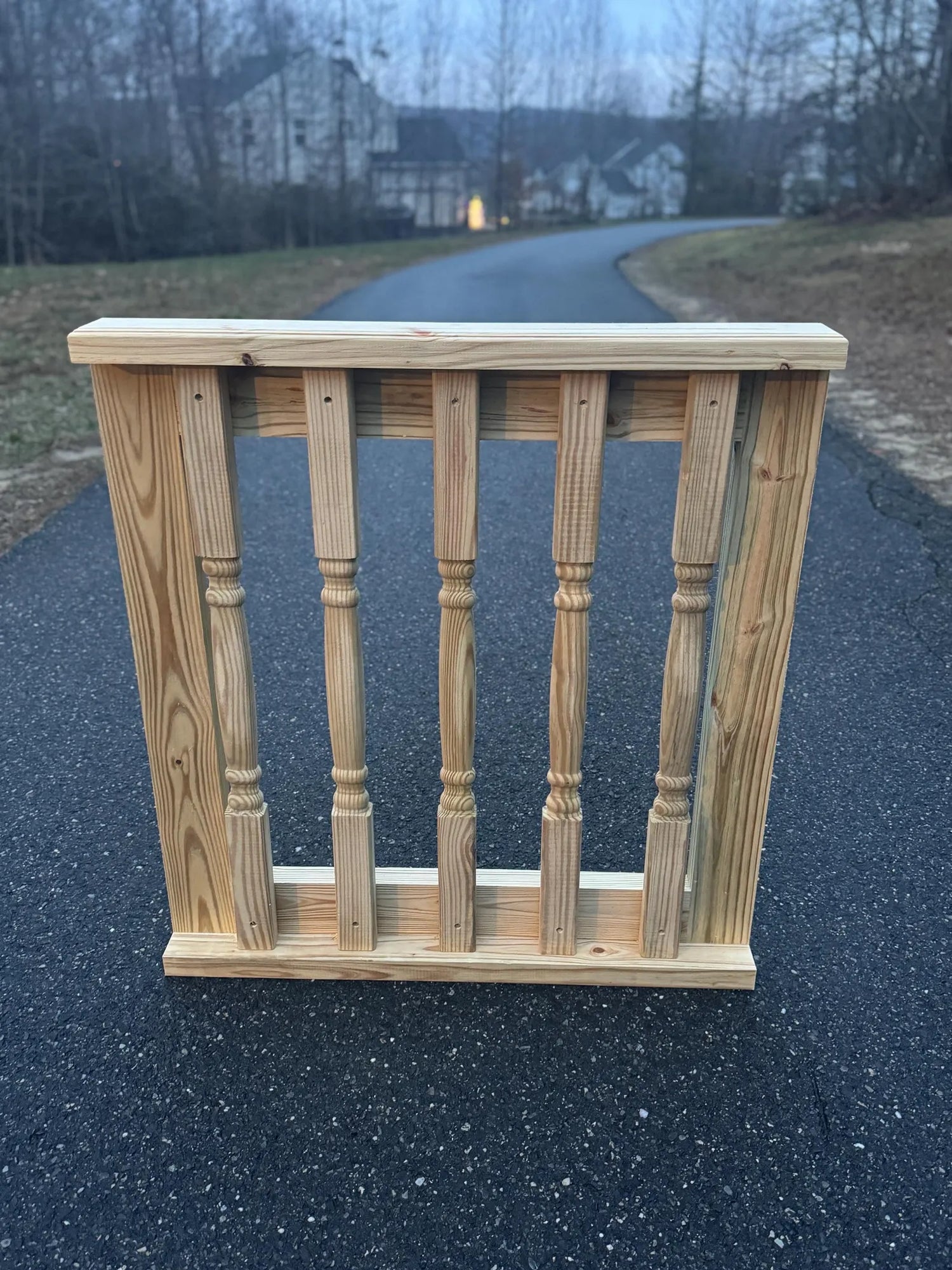 Front view of a decorative wooden baluster gate, showcasing intricate baluster design and sturdy wooden frame, suitable for patios and decks.